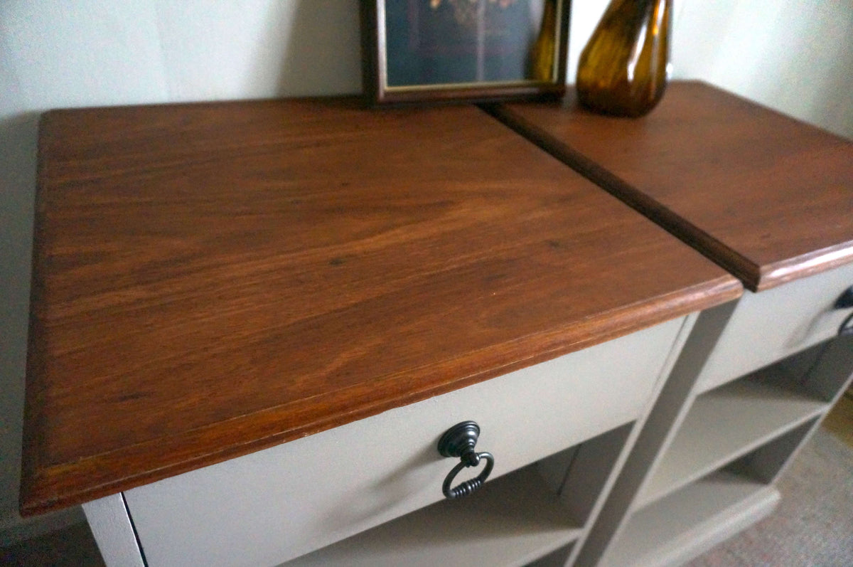A jarrah bedside table with a medium brown wood grain top, a Velvet Taupe painted base, and a single drawer with a black metal pull handle.